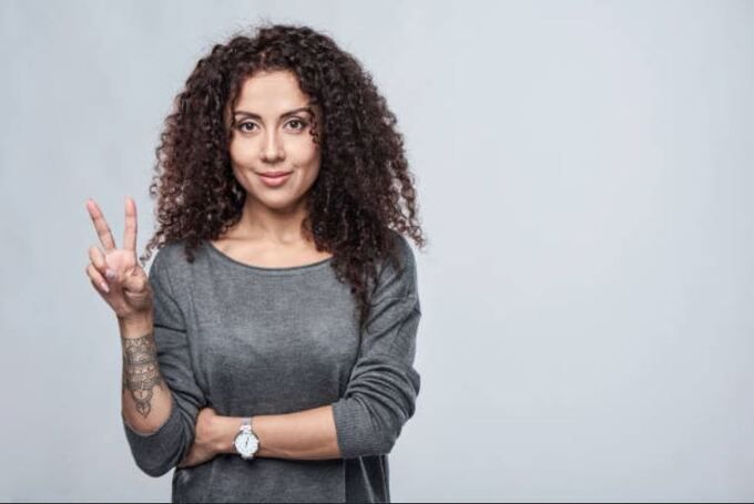 Woman Holding Up Two Fingers